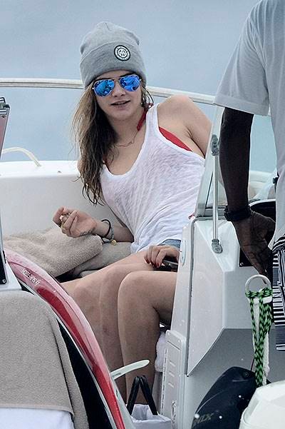Cara Delevingne is spotted on a boat while on holiday in Barbados