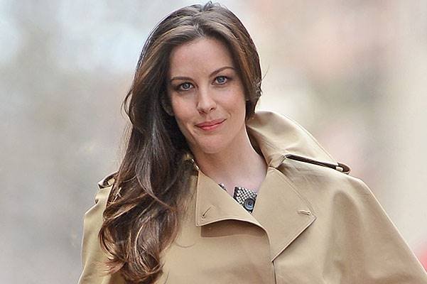 Liv Tyler poses in trench coat for fashion photo shoot in New York City