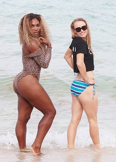 Serena Williams and Caroline Wozniacki pose for pictures at the beach in Miami Beach