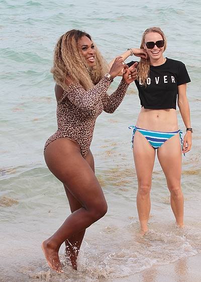 Serena Williams and Caroline Wozniacki pose for pictures at the beach in Miami Beach