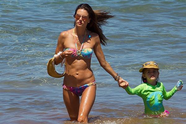 Alesandra Ambrosio seen in a tie-dyed bikini, as she has beach fun and paddle boards in Maui.